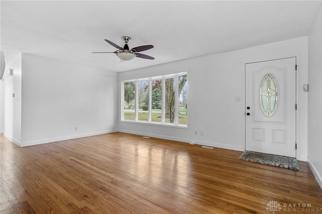 entrance foyer with ceiling fan and wood-type flooring