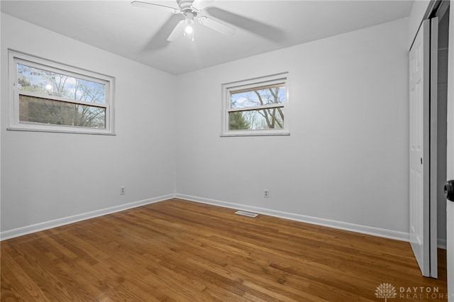 unfurnished bedroom with hardwood / wood-style floors, a closet, and ceiling fan