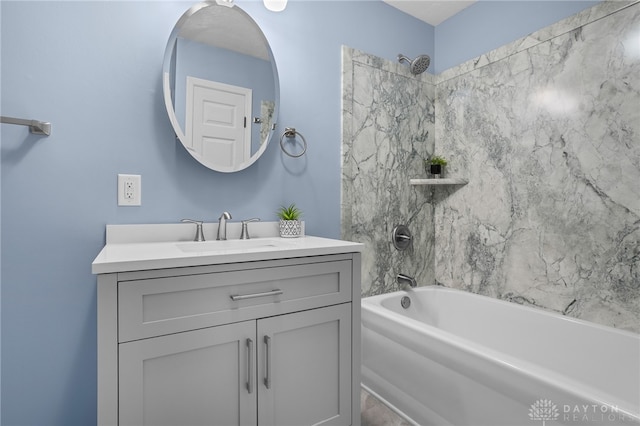 bathroom with tiled shower / bath combo and vanity