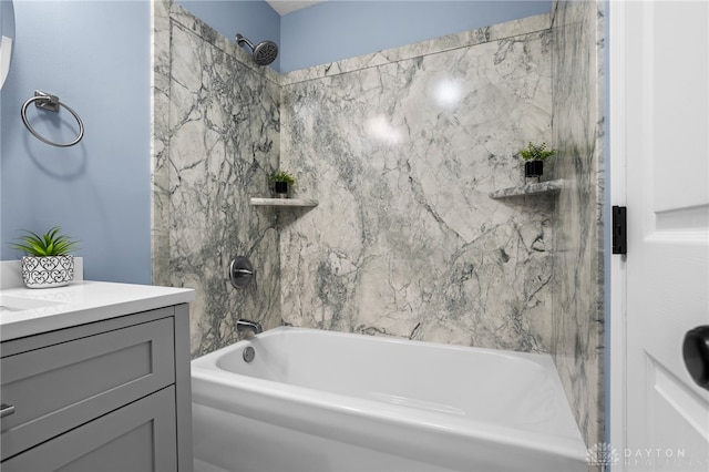 bathroom with tiled shower / bath combo and vanity