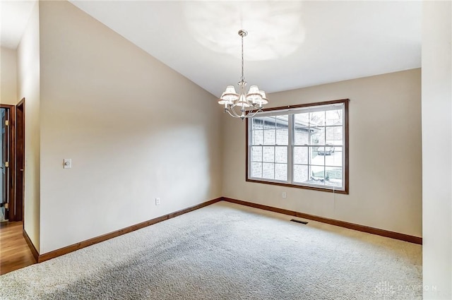 unfurnished room featuring an inviting chandelier, carpet, and lofted ceiling