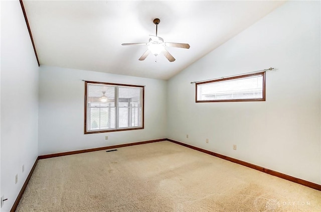 carpeted spare room with ceiling fan and lofted ceiling