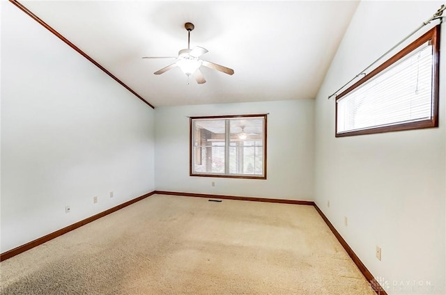 unfurnished room featuring ceiling fan, lofted ceiling, and light colored carpet