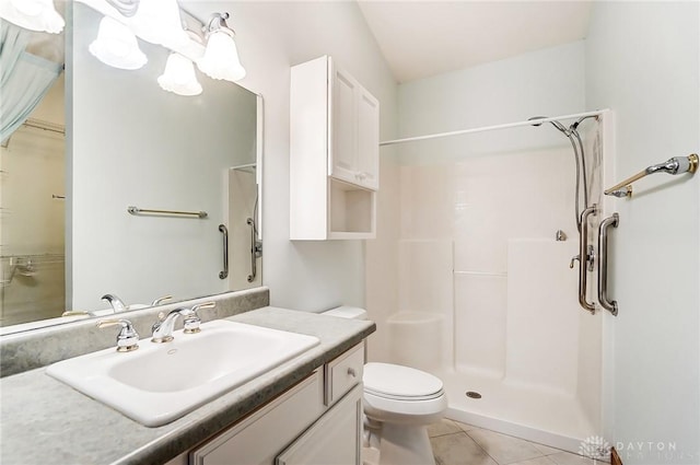 bathroom with toilet, tile patterned flooring, walk in shower, and vanity