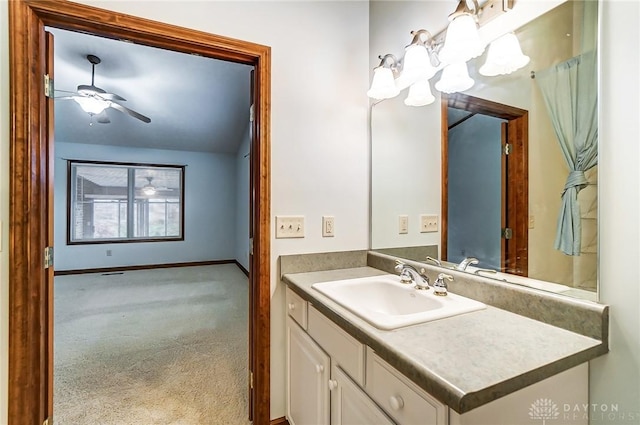 bathroom featuring ceiling fan, lofted ceiling, and vanity