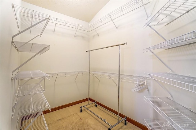 spacious closet with carpet and lofted ceiling