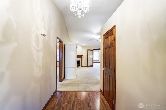 corridor featuring a chandelier and wood-type flooring