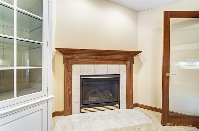 interior details featuring a tiled fireplace