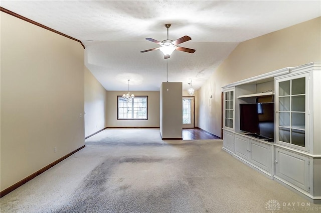 unfurnished living room with light carpet, vaulted ceiling, and ceiling fan with notable chandelier