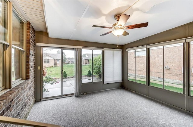 unfurnished sunroom featuring ceiling fan