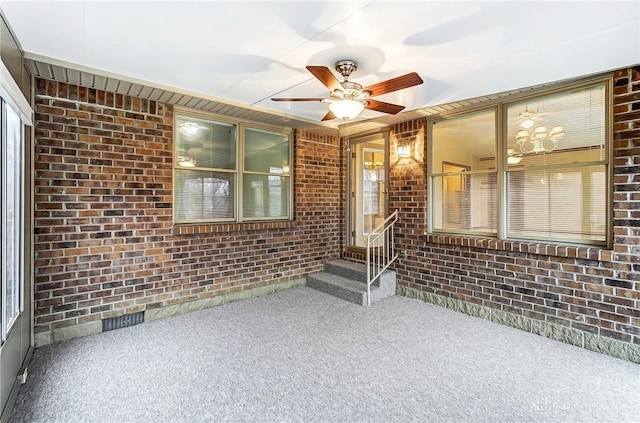 property entrance with ceiling fan and a patio