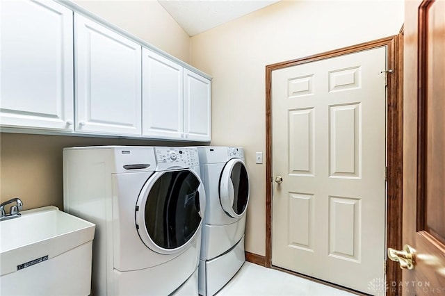 washroom featuring cabinets, separate washer and dryer, light tile patterned floors, and sink