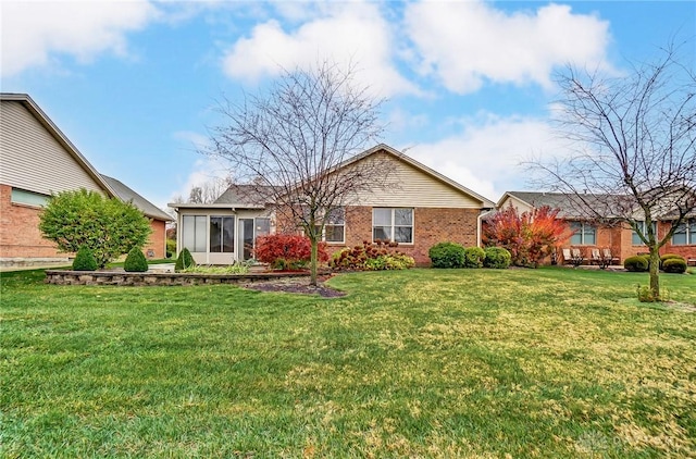 view of front of property featuring a sunroom and a front yard