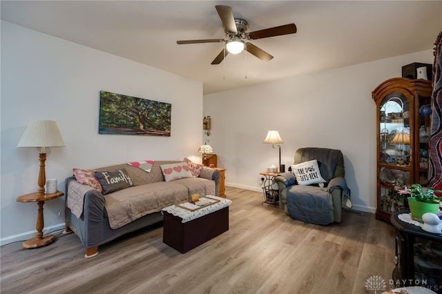 living room featuring ceiling fan and hardwood / wood-style floors