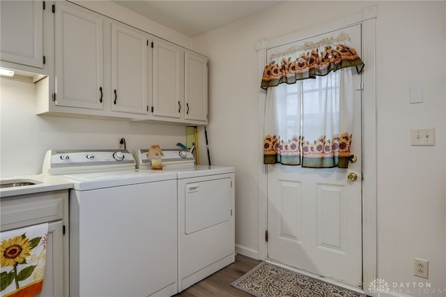 laundry area featuring cabinets, independent washer and dryer, and light wood-type flooring