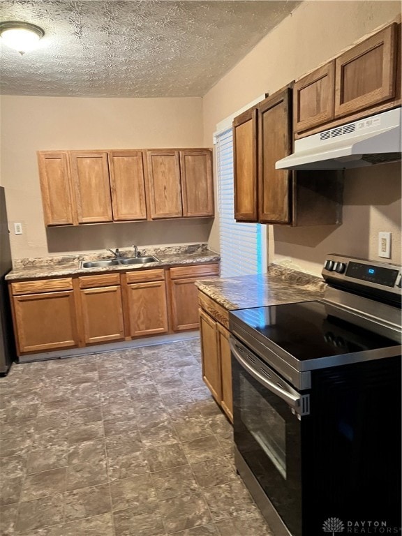 kitchen with sink, stainless steel appliances, and a textured ceiling