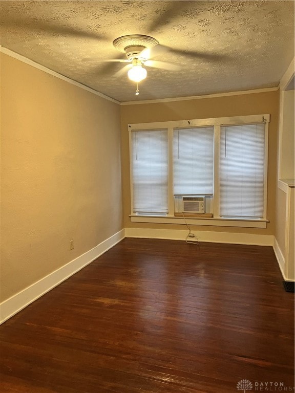 unfurnished room featuring cooling unit, dark hardwood / wood-style floors, ceiling fan, ornamental molding, and a textured ceiling