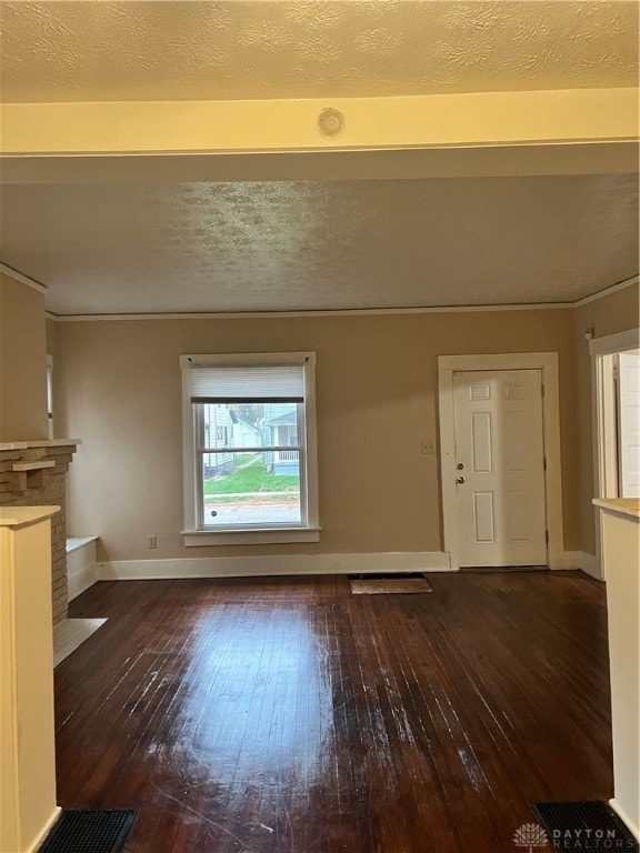 unfurnished living room featuring dark hardwood / wood-style flooring and a textured ceiling