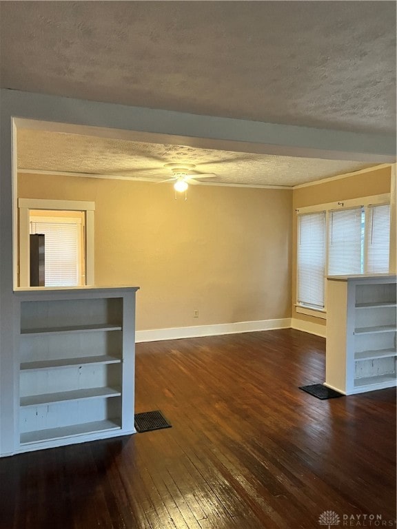 unfurnished living room featuring a textured ceiling, ceiling fan, and dark wood-type flooring