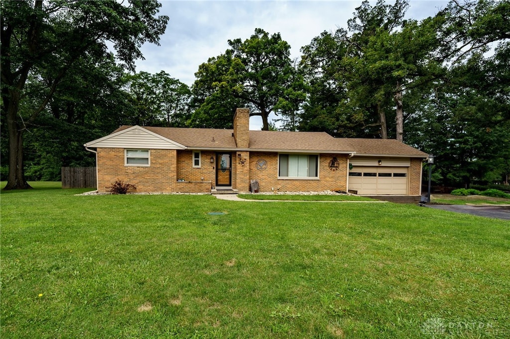 ranch-style house with a garage and a front yard