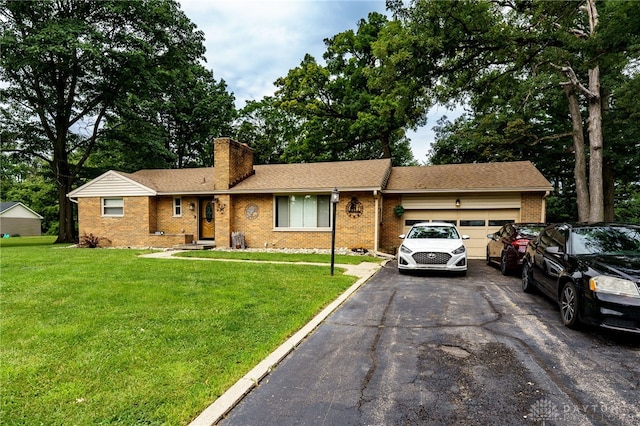 single story home with a garage and a front lawn