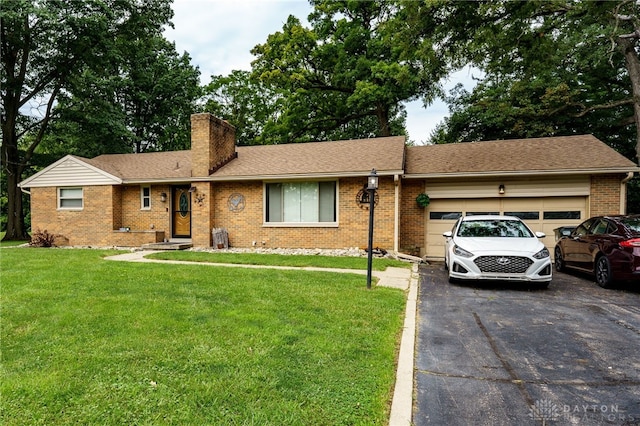 single story home featuring a garage and a front lawn