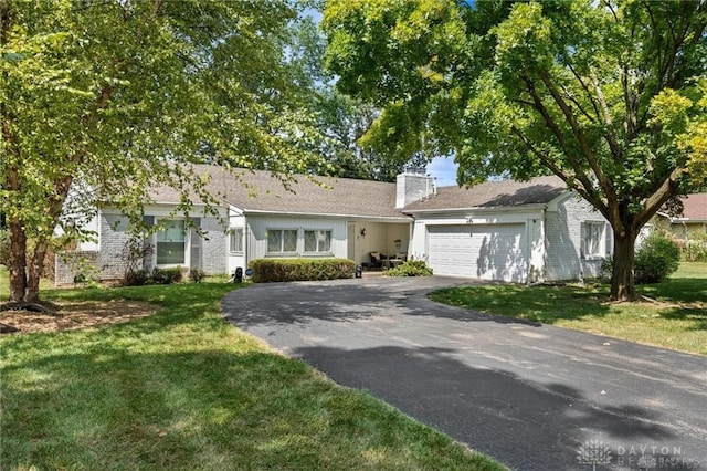 ranch-style house with a front yard and a garage