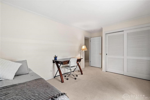 bedroom featuring ornamental molding, light carpet, and a closet