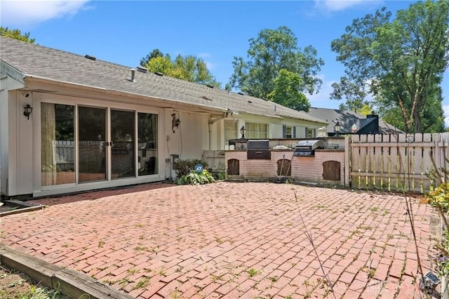 rear view of property with a patio and area for grilling