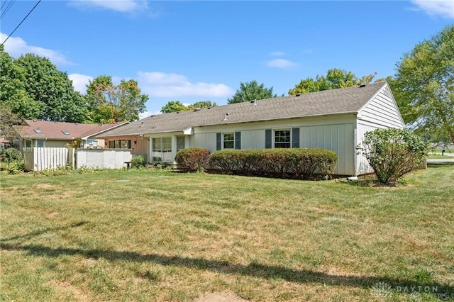 back of property featuring a lawn