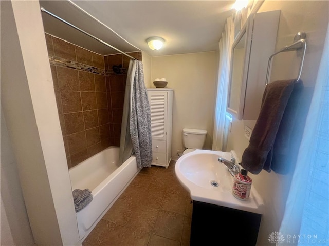 full bathroom with tile patterned flooring, shower / tub combo, vanity, and toilet