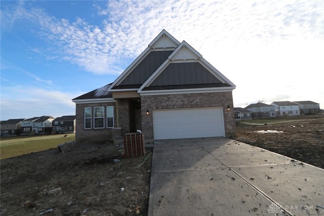 view of front of home with board and batten siding, a residential view, brick siding, and driveway