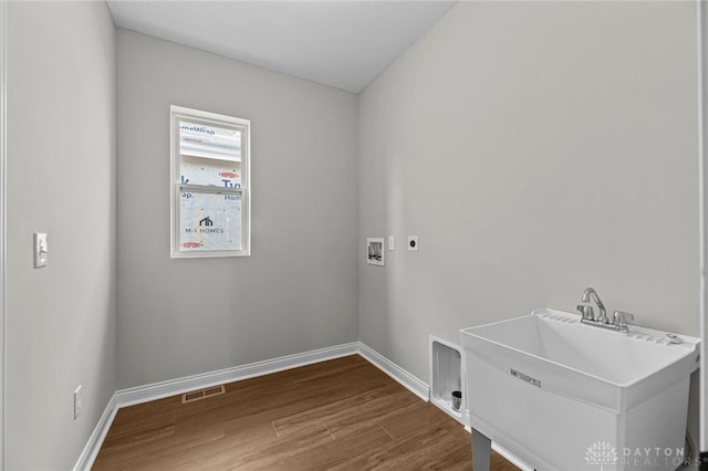 washroom featuring hookup for a washing machine, visible vents, electric dryer hookup, wood finished floors, and laundry area