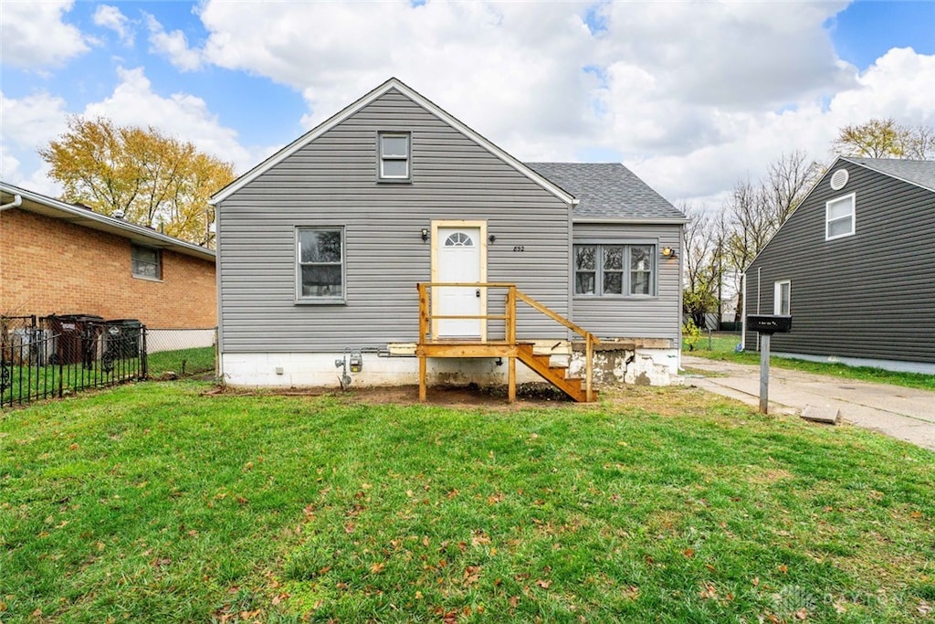 rear view of house with a lawn