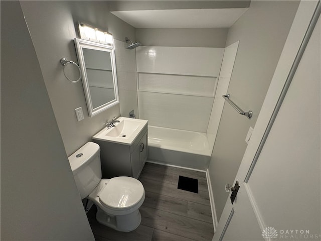 full bathroom with bathing tub / shower combination, hardwood / wood-style floors, vanity, and toilet