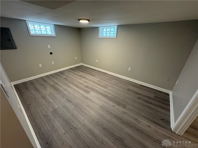 basement with wood-type flooring and electric panel