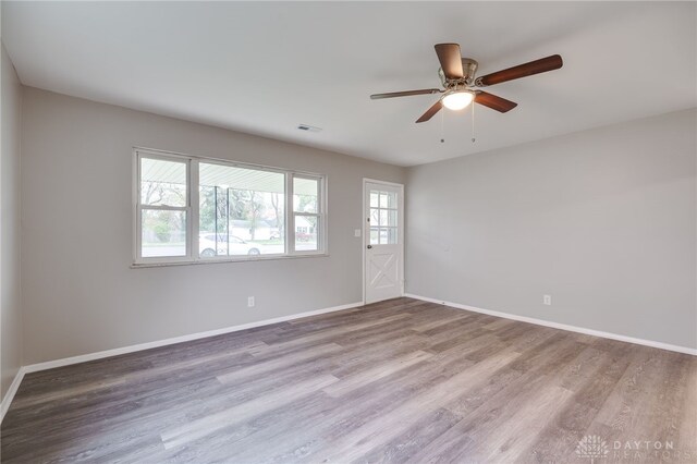 spare room with ceiling fan and wood-type flooring