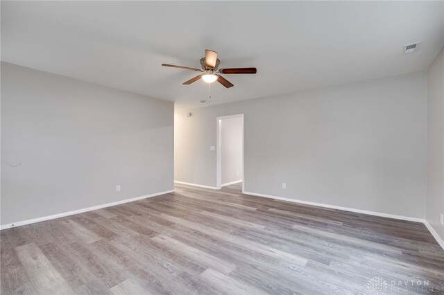 spare room featuring light wood-type flooring and ceiling fan