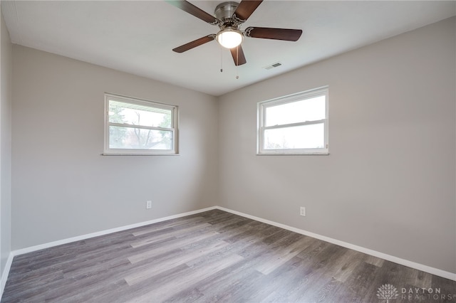 empty room with light hardwood / wood-style flooring, ceiling fan, and a healthy amount of sunlight