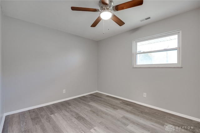 spare room featuring ceiling fan and light hardwood / wood-style floors