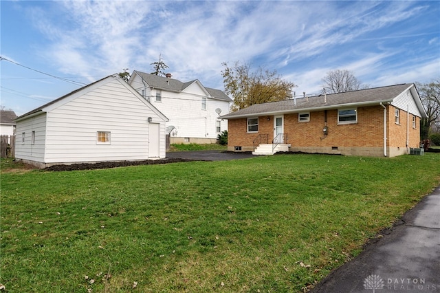 back of property featuring a lawn