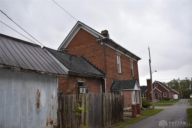 view of side of home featuring cooling unit