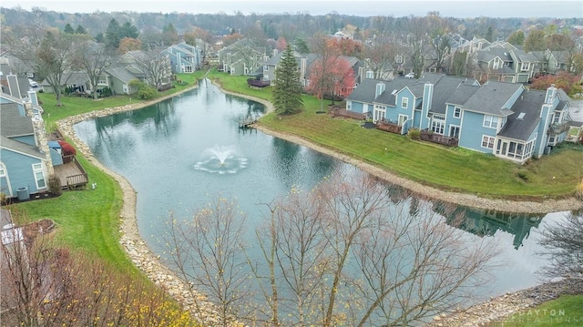 drone / aerial view featuring a water view and a residential view