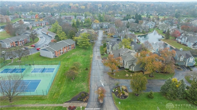 drone / aerial view featuring a residential view and a water view