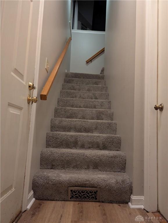 stairway with wood finished floors