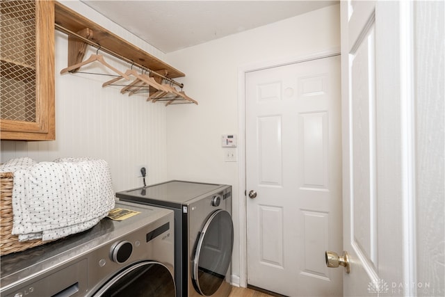 laundry room featuring light wood-type flooring and washing machine and clothes dryer