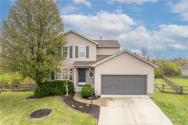 view of property featuring a garage and a front lawn