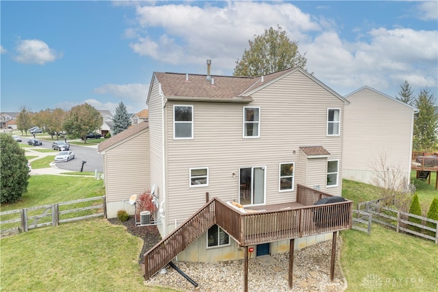 back of property with a yard, central air condition unit, and a wooden deck