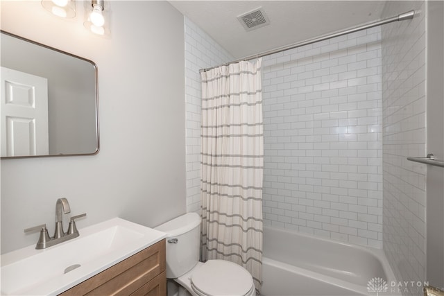 full bathroom with a textured ceiling, vanity, shower / tub combo, and toilet