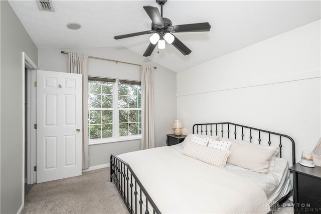 bedroom with ceiling fan, light colored carpet, and vaulted ceiling